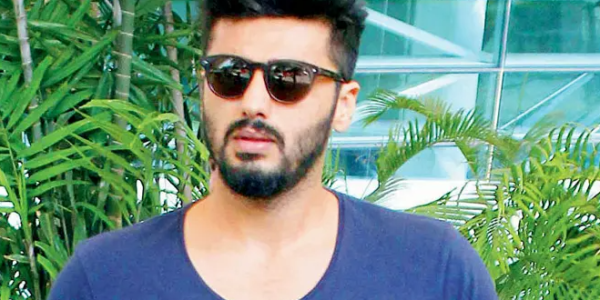 Arjun Kapoor, a prominent Bollywood actor, posing at a promotional event, showcasing his charismatic personality.