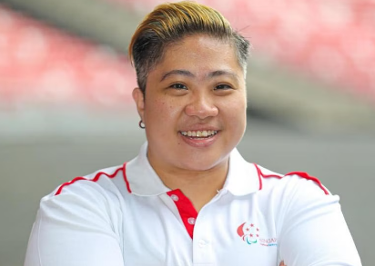 Theresa Goh Rui Si proudly holding her bronze medal from the 2016 Rio Paralympics, symbolizing years of dedication and resilience in Paralympic swimming.