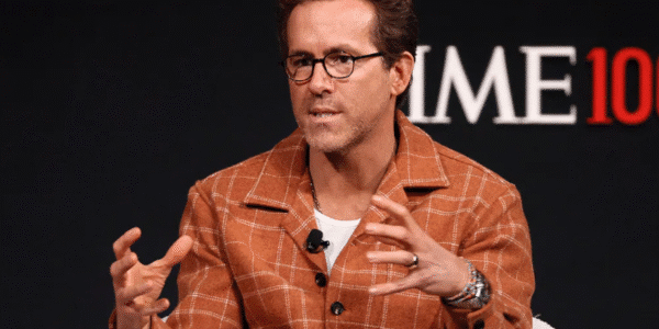 Ryan Reynolds smiling at a red carpet event.