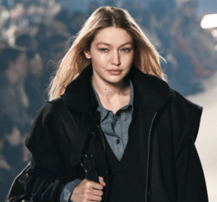 Gigi Hadid posing on the runway in a designer outfit at New York Fashion Week