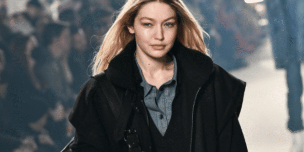 Gigi Hadid posing on the runway in a designer outfit at New York Fashion Week