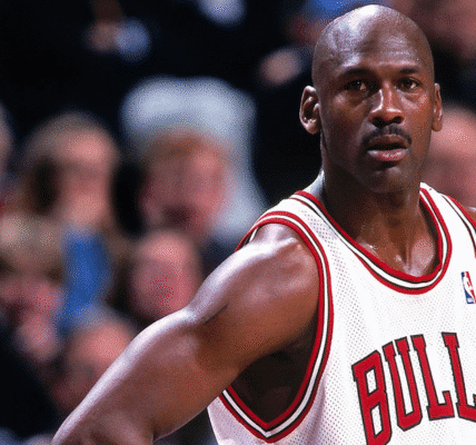 Michael Jordan biography portrait during an NBA game showcasing his iconic jump shot and Air Jordan sneakers